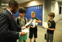 Grissom Principal Jean Milfort with students