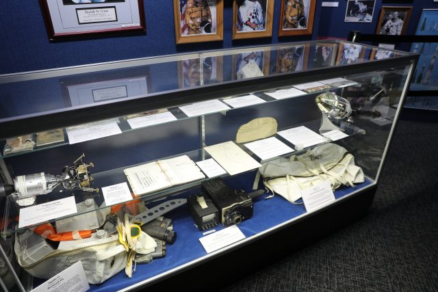 A display case filled with various items, including a collection of sports memorabilia and possibly a few other objects,