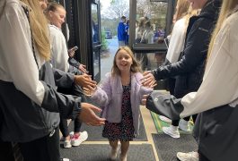 student receives high fives