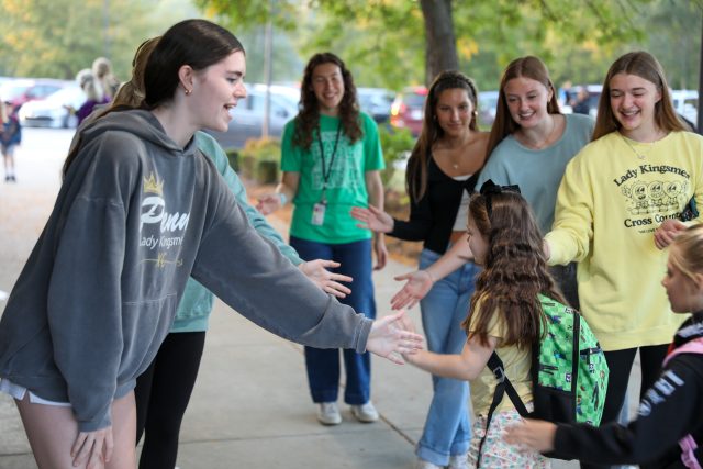 students high fiving each other