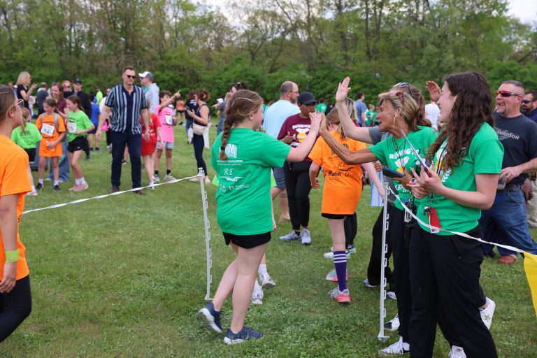 Running is Elementary: staff congratulate runners as they finish